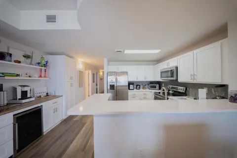 a view of a balcony with two chairs and a potted plant
