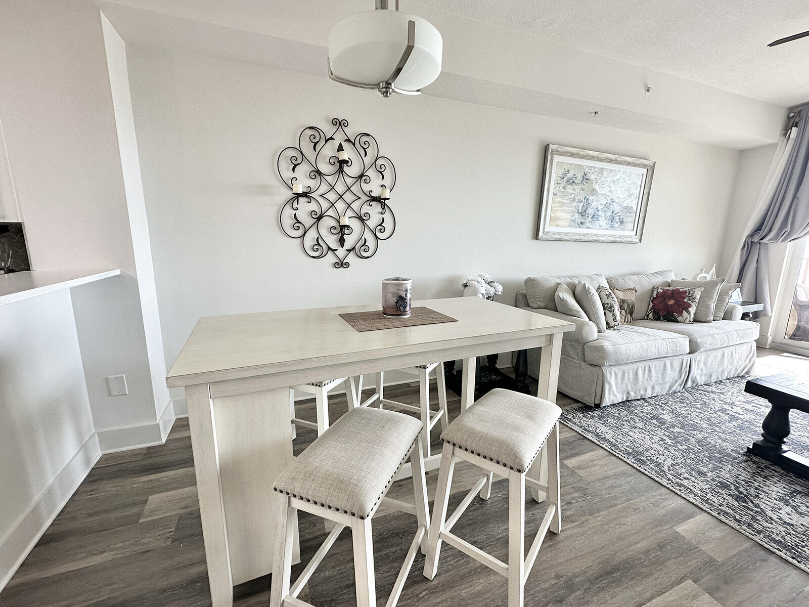 15928 Front Beach Road, Unit 32011 Panama City Beach, FL 32413 - Photo 23 of 84 a view of a dining room with furniture and wooden floor