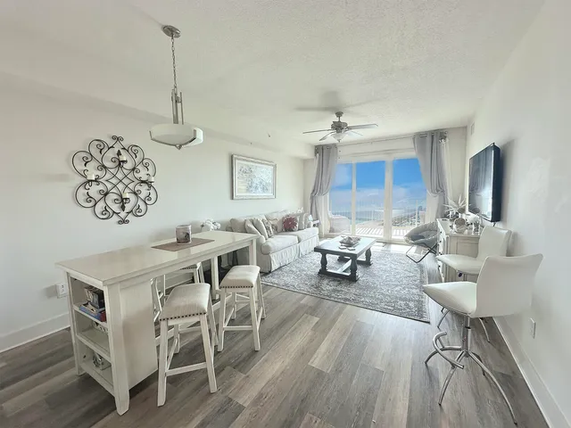 a bedroom with a bed and a flat tv screen on dresser