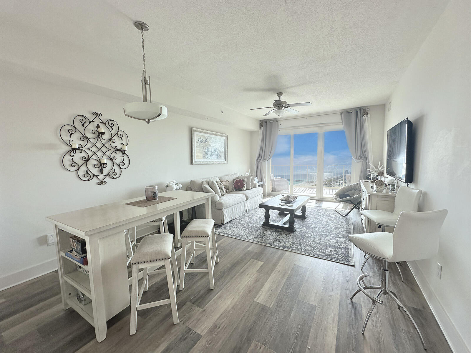 15928 Front Beach Road, Unit 32011 Panama City Beach, FL 32413 - Photo 24 of 84 a living room with furniture and a table