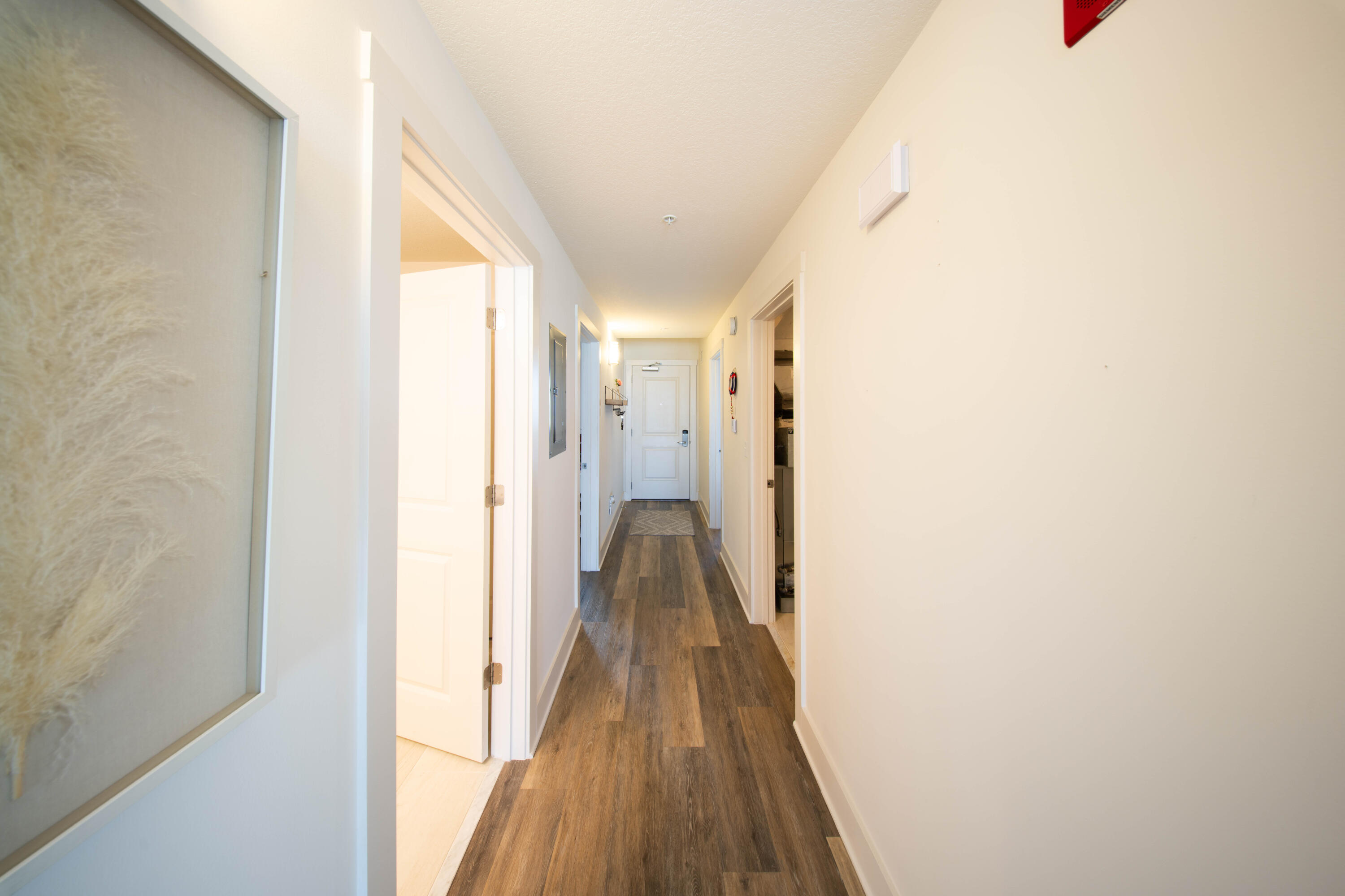 15928 Front Beach Road, Unit 32011 Panama City Beach, FL 32413 - Photo 33 of 84 a view of a hallway with wooden floor