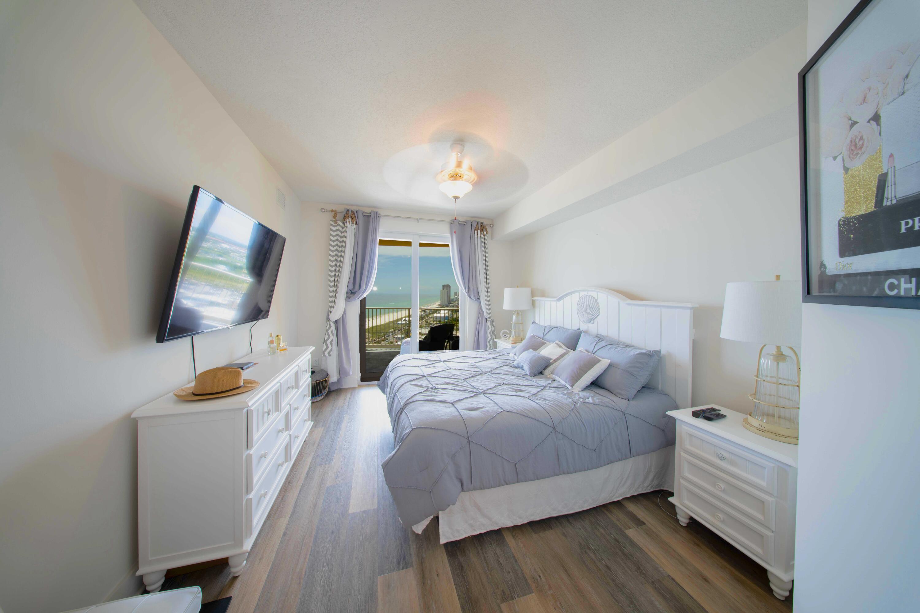 15928 Front Beach Road, Unit 32011 Panama City Beach, FL 32413 - Photo 34 of 84 a bedroom with a bed and a flat screen tv