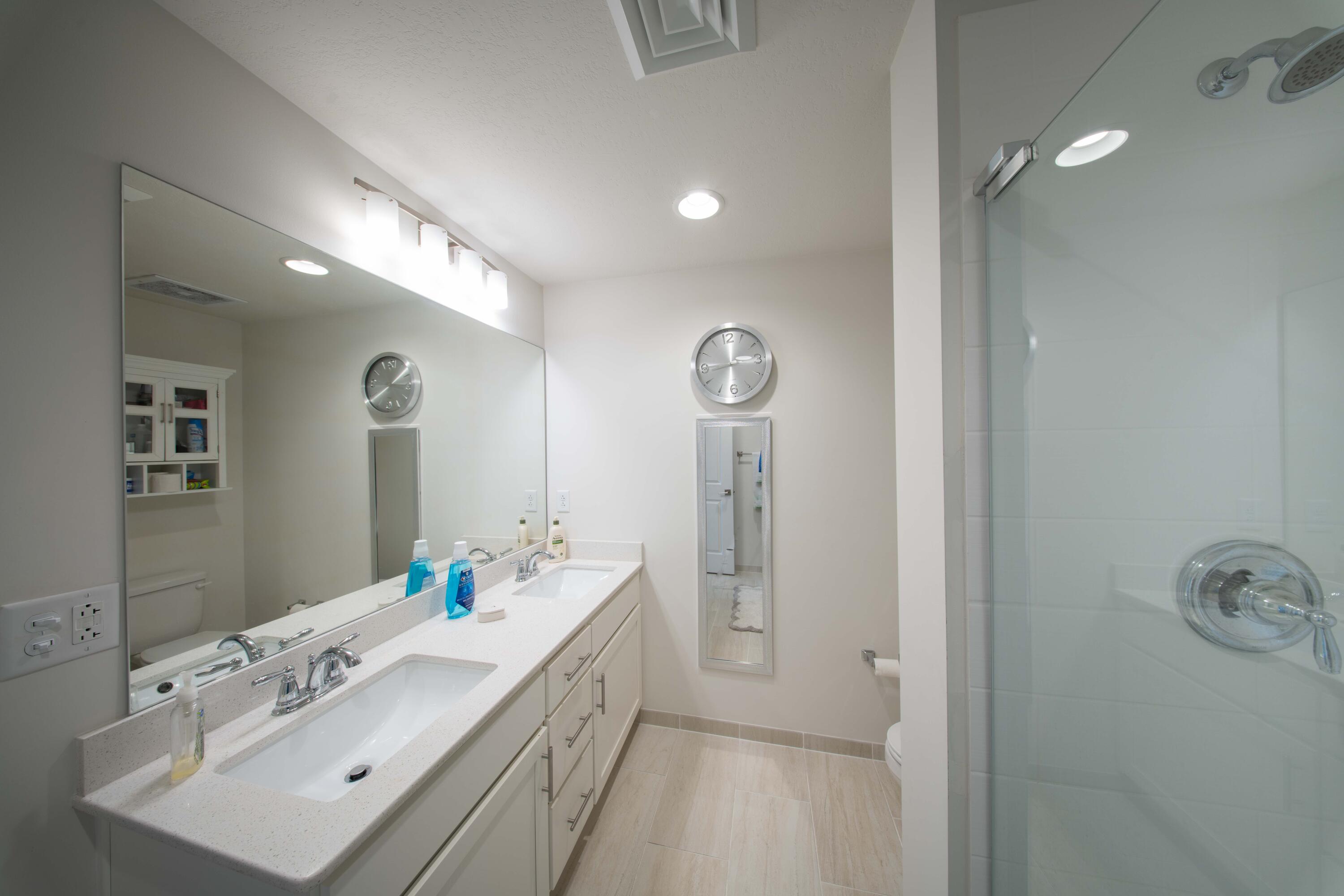 15928 Front Beach Road, Unit 32011 Panama City Beach, FL 32413 - Photo 38 of 84 a bathroom with a sink vanity granite tub and shower