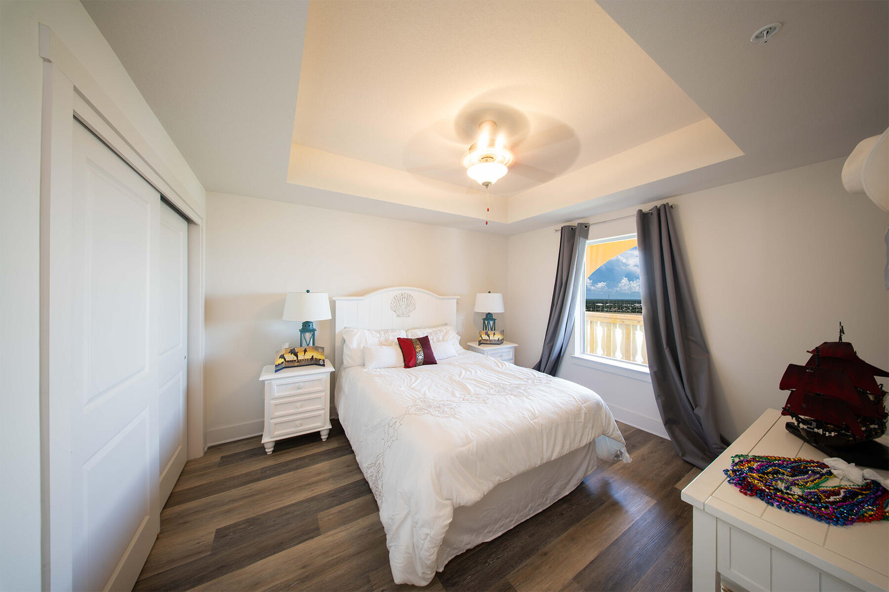 15928 Front Beach Road, Unit 32011 Panama City Beach, FL 32413 - Photo 39 of 84 a bedroom with a bed and a chandelier