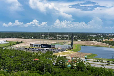 a view of a backyard with swimming pool and furniture