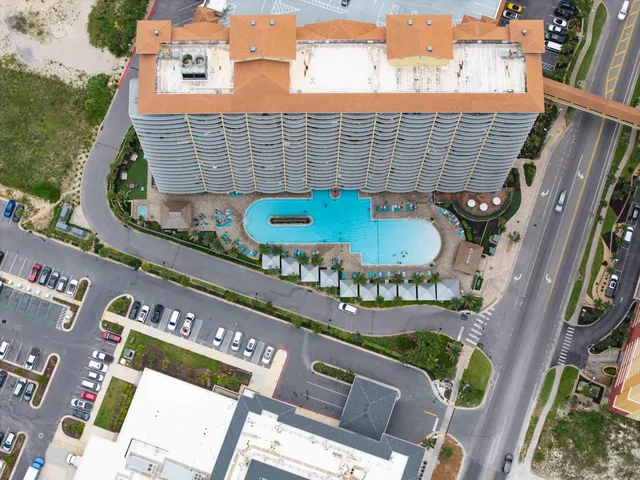 a living room with stainless steel appliances furniture a refrigerator and a kitchen counter top