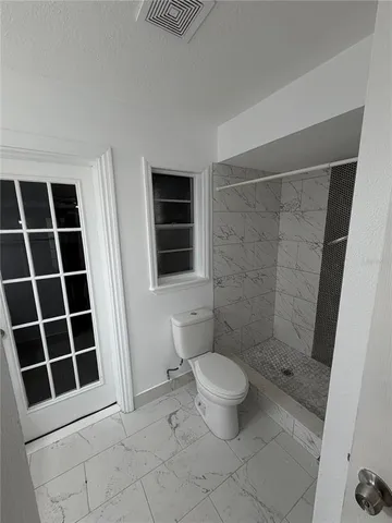 a front view of house with yard and trees around