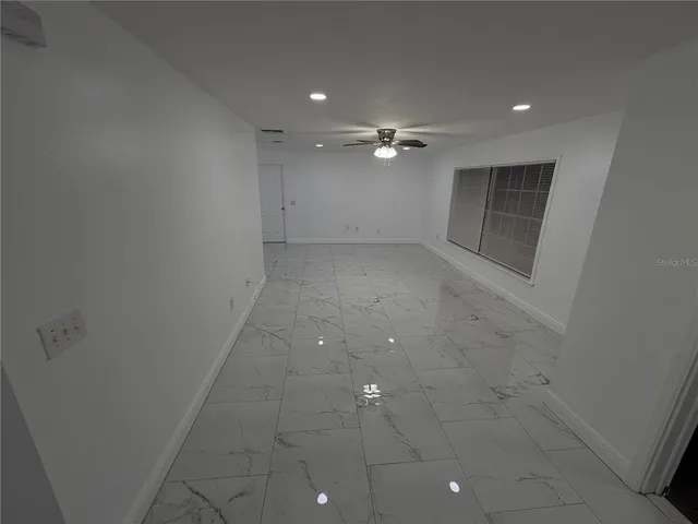 an empty room with a fireplace and painted walls