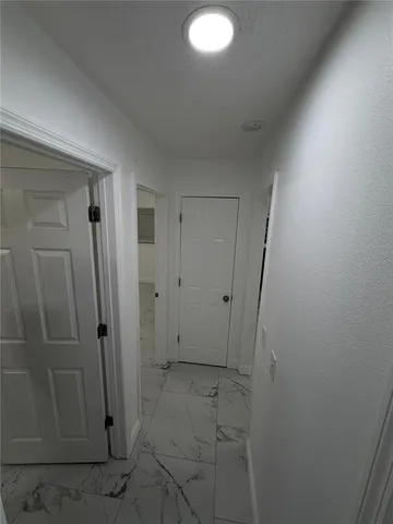 en empty room with windows and fan