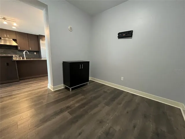 a view of kitchen with wooden floor and electronic appliances