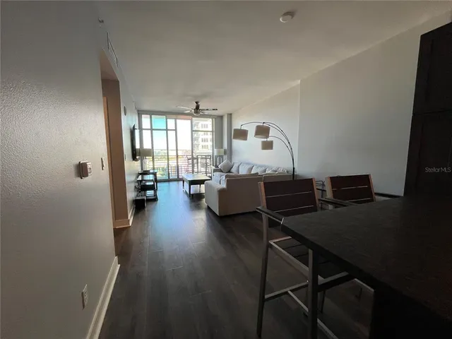 a living room with furniture and a wooden floor