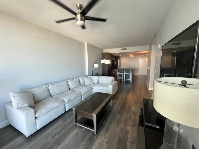 a living room with furniture and a wooden floor
