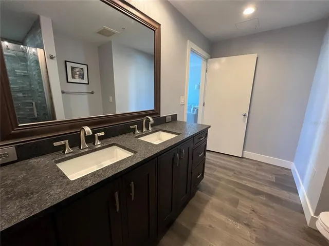 a bathroom with a double vanity sink and a mirror