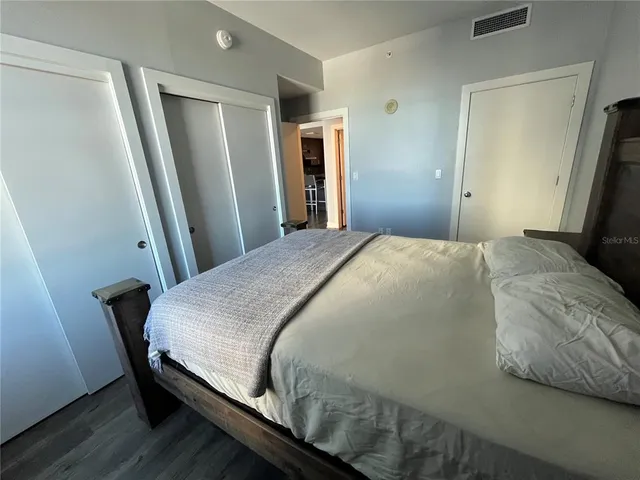 a bedroom with a bed and a mirror