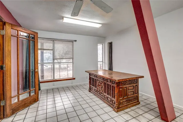 a living room with a baby crib furniture and a window