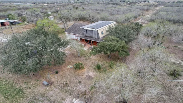 a aerial view of a house with a yard