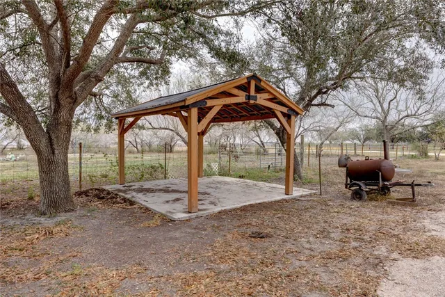 a backyard of a house with table and chairs