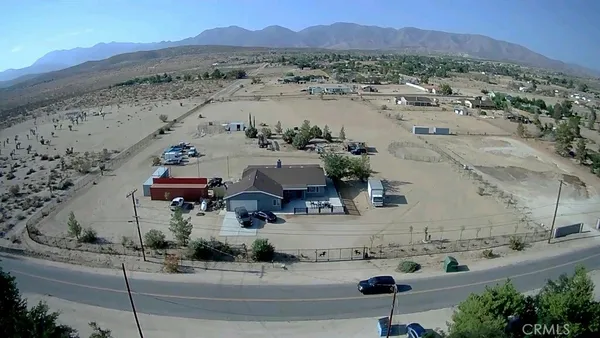 an aerial view of house with a yard