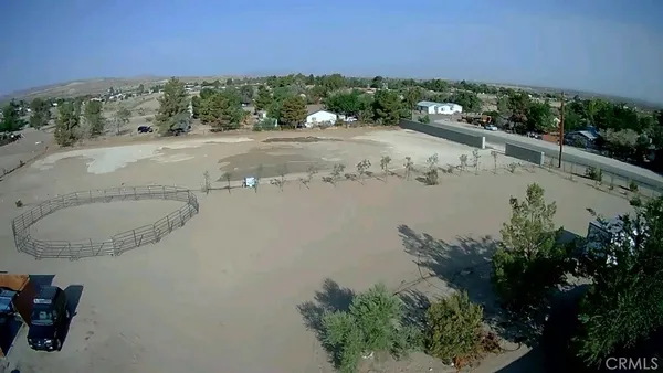 an aerial view of a house with a yard and lake view