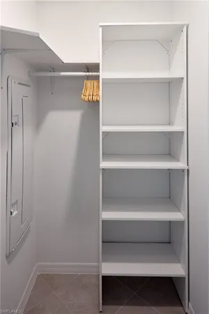 a view of walk in closet with empty racks