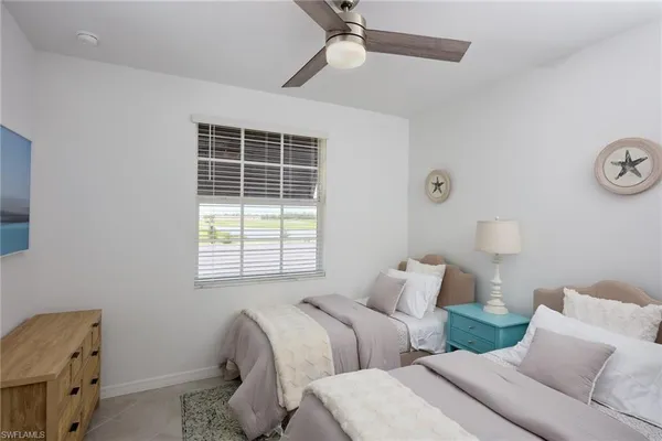 a bedroom with two beds and a window