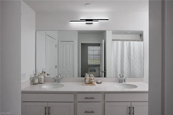a bathroom with 2 sink and a mirror