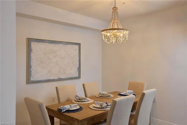 a view of a dining room with furniture and chandelier