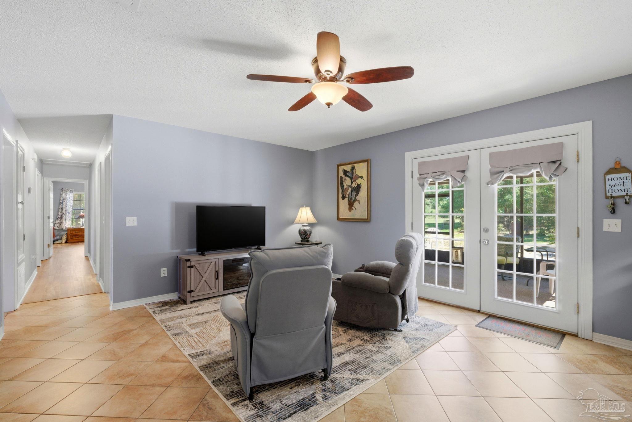 5121 Keyser Mill Road Baker, FL 32531 - Photo 24 of 52 a living room with furniture and a flat screen tv
