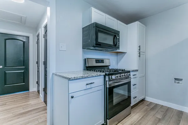 a kitchen with a stove and a microwave
