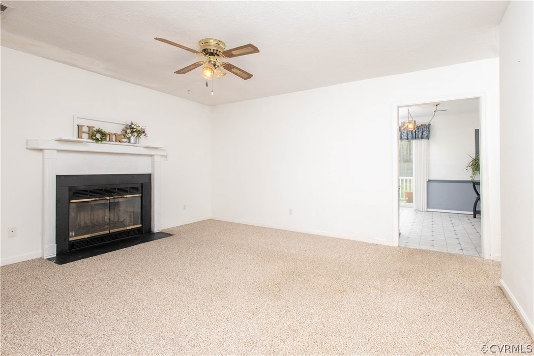 10225 Ridgerun Road Chesterfield, VA 23832 - Photo 13 of 33 a view of a livingroom with a fireplace and a chandelier fan