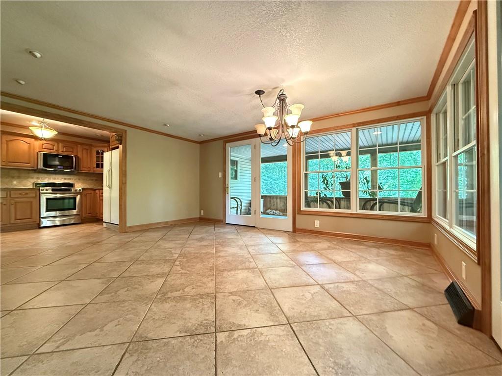 301 Hopper Road Transfer, PA 16154 - Photo 18 of 48 a view of an empty room with a fireplace and a window