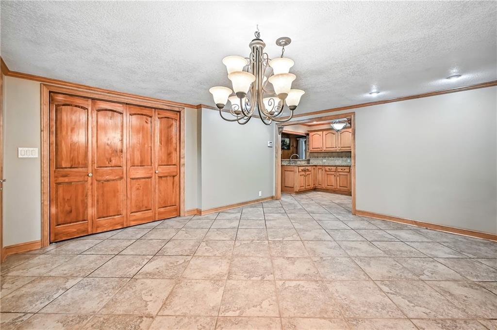 301 Hopper Road Transfer, PA 16154 - Photo 20 of 48 a view of a livingroom with a chandelier fan and kitchen view