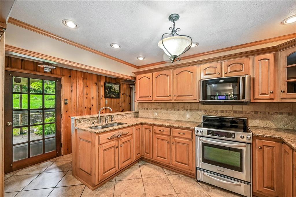 301 Hopper Road Transfer, PA 16154 - Photo 21 of 48 a kitchen with stainless steel appliances granite countertop a stove and a microwave