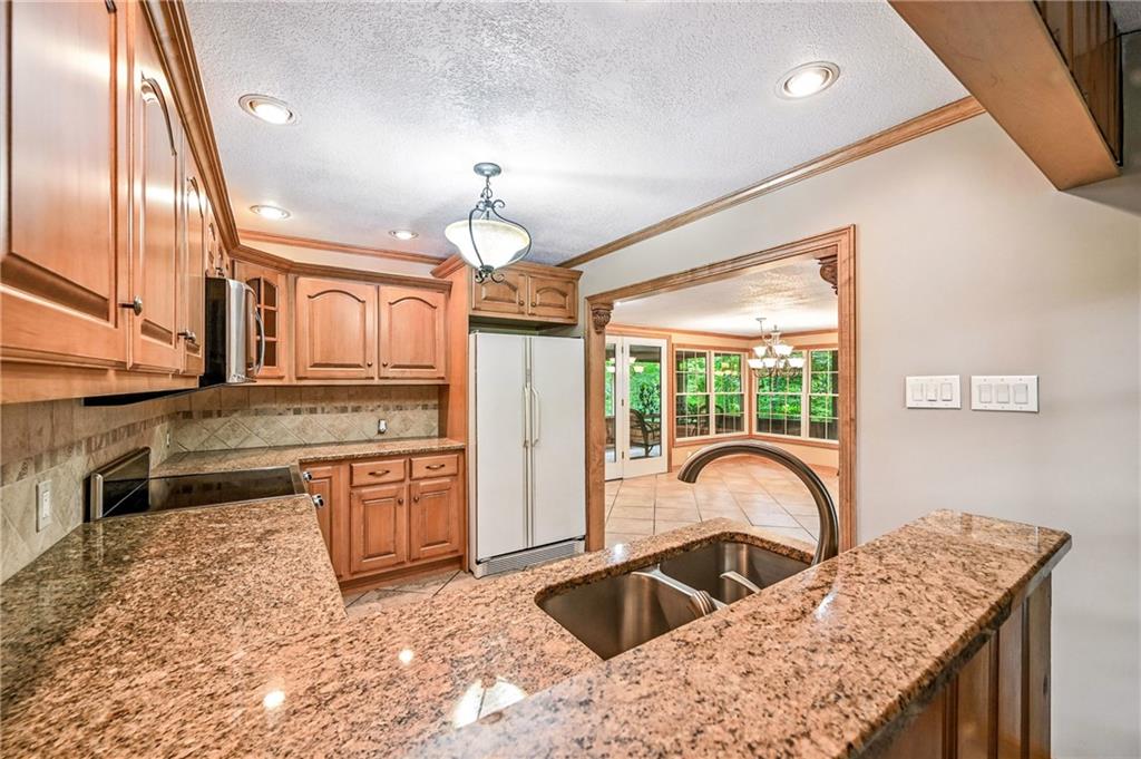 301 Hopper Road Transfer, PA 16154 - Photo 24 of 48 a kitchen with stainless steel appliances granite countertop a sink a stove and a refrigerator