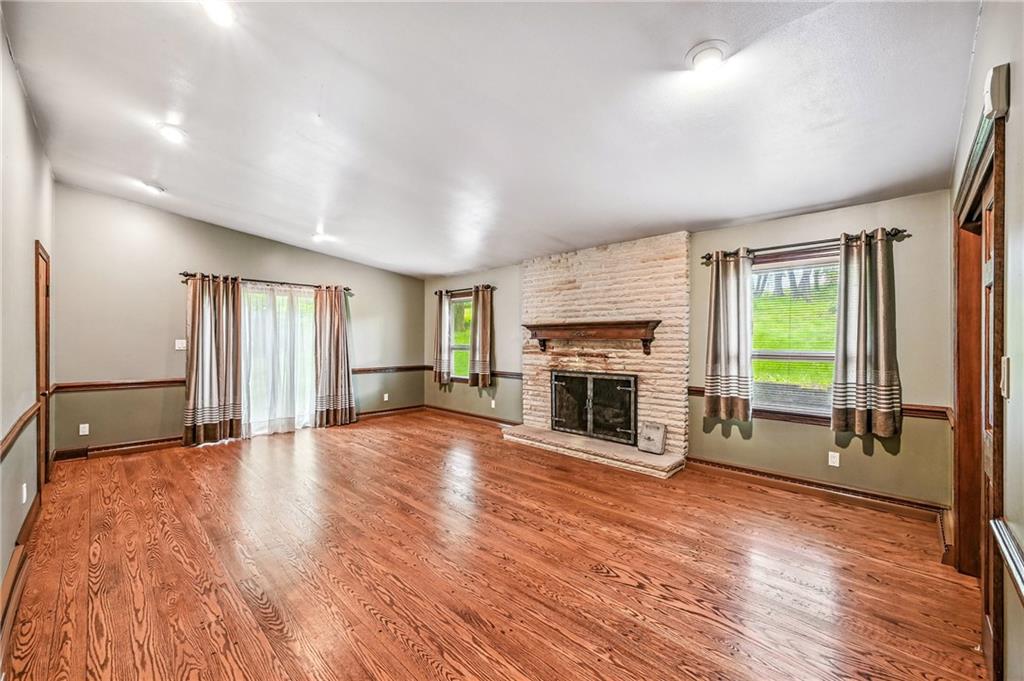 301 Hopper Road Transfer, PA 16154 - Photo 25 of 48 a view of empty room with wooden floor and fireplace