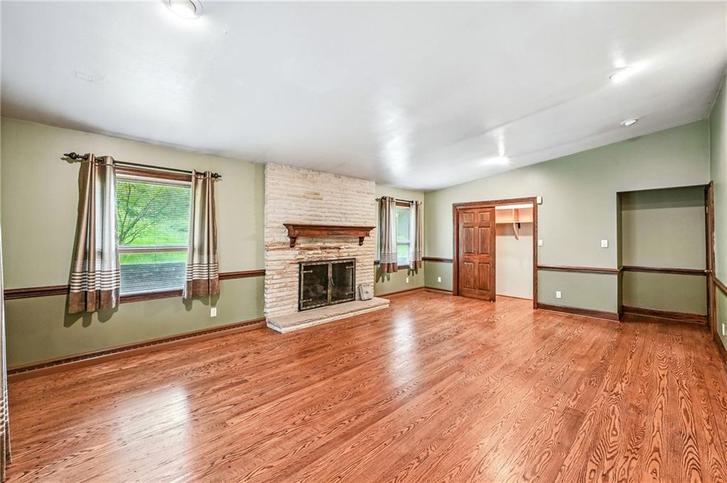 301 Hopper Road Transfer, PA 16154 - Photo 26 of 48 a view of empty room with wooden floor and fireplace