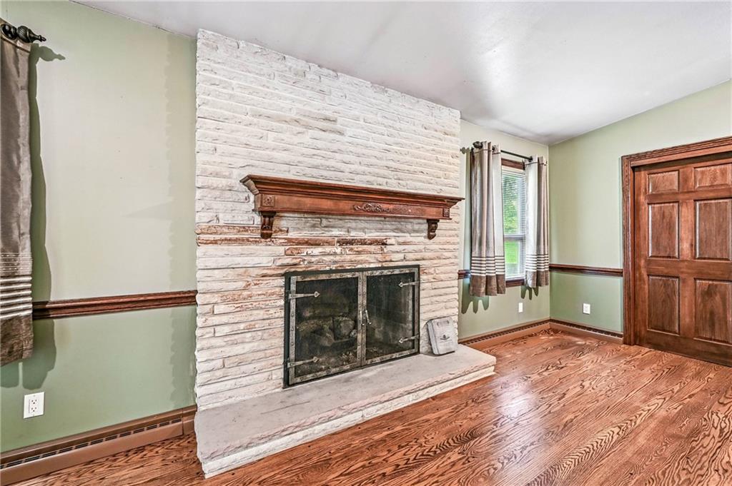 301 Hopper Road Transfer, PA 16154 - Photo 28 of 48 a view of a livingroom with a fireplace wooden floor and staircase