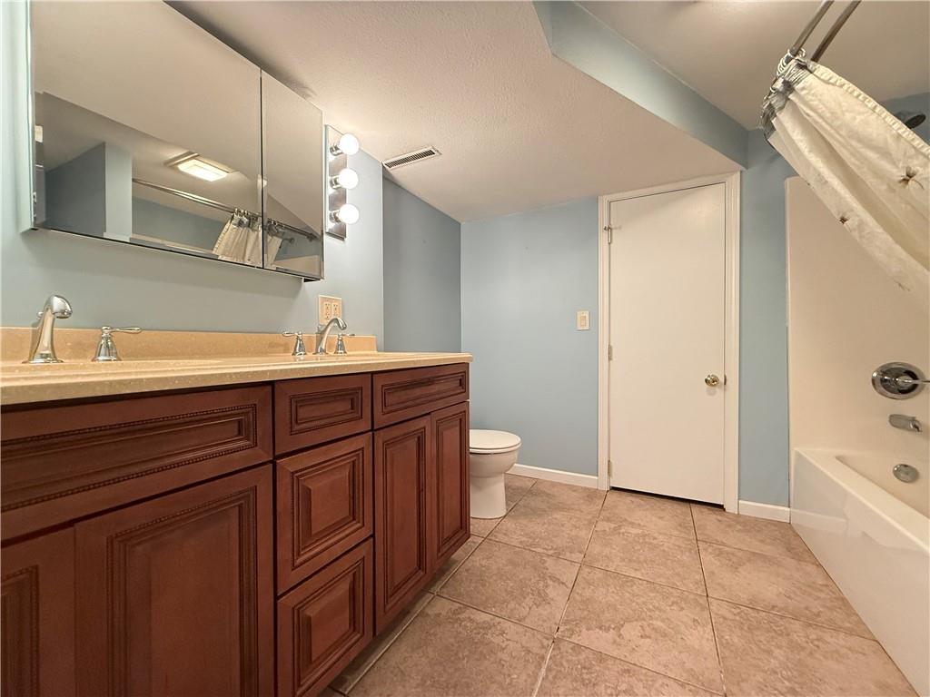 301 Hopper Road Transfer, PA 16154 - Photo 41 of 48 a spacious bathroom with a sink a toilet and a large mirror