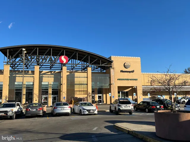a front view of building with cars parked