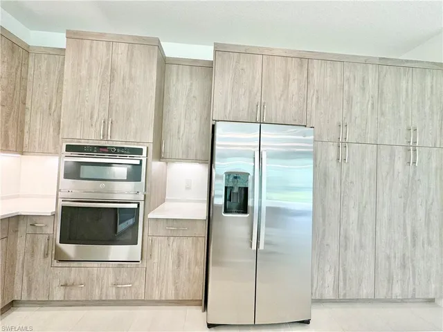a kitchen with appliances and cabinets