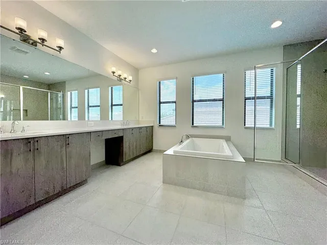 a large spacious bathroom with a large tub shower and checkered floor