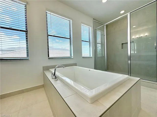 a bathroom with a bathtub and shower