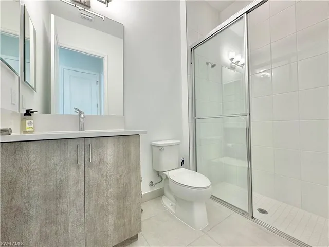 a bathroom with a shower toilet and sink