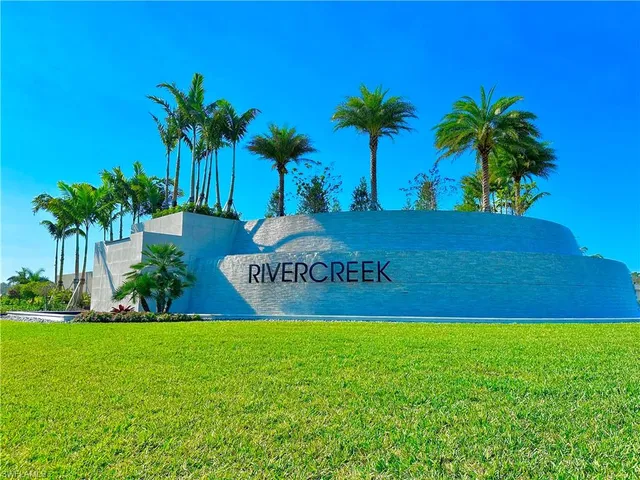 a sign that is sitting in front of the grass