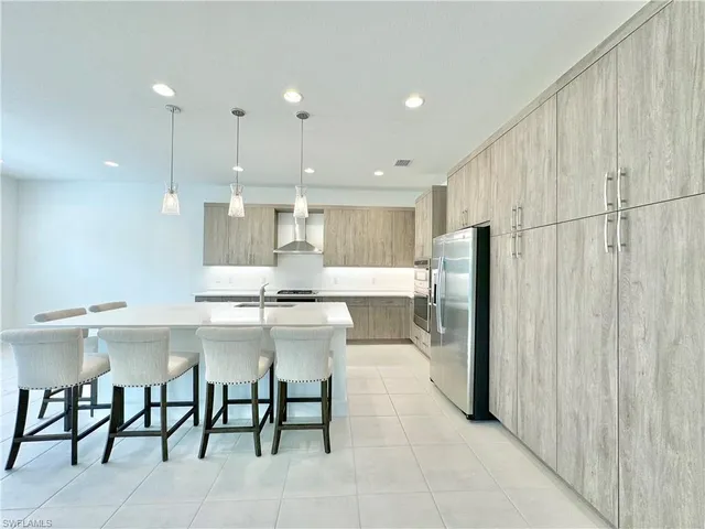 a large kitchen with a table and chairs