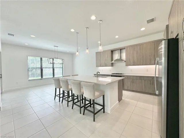 a large kitchen with a table and chairs