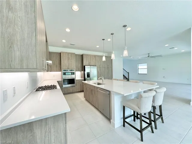 a white kitchen with a table and chairs