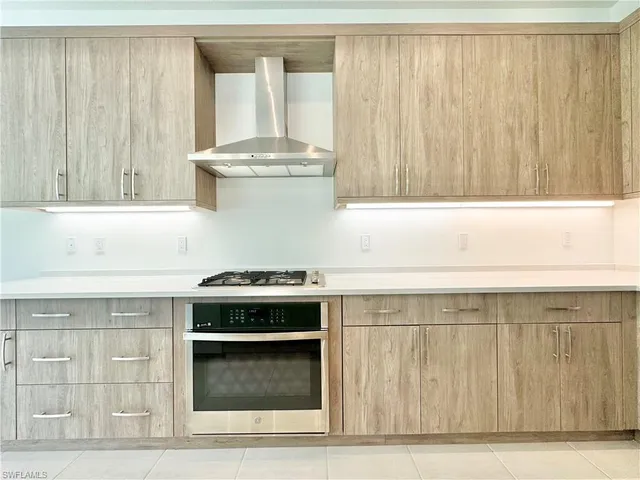 a view of a kitchen with a sink and a wooden floor