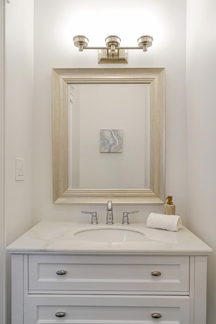 9 North Ada Street Chicago, IL 60607 - Photo 23 of 39 a bathroom with a sink and a mirror