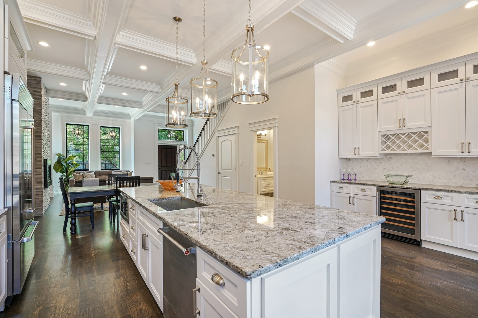 9 North Ada Street Chicago, IL 60607 - Photo 6 of 39 a kitchen with kitchen island granite countertop a stove a sink a dining table and chairs with wooden floor